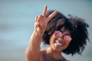Woman Wearing Sunglasses Making Peace Hand Symbol